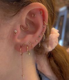 a close up of a person with ear piercings on their left and right ears