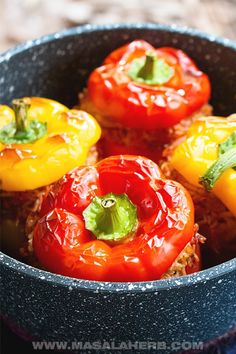 some red and yellow peppers are in a blue bowl