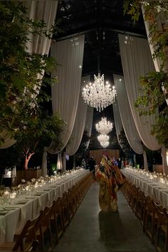 an indoor dining area with chandeliers and tables set for formal function or party