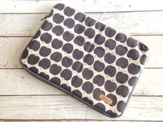 a black and white polka dot purse sitting on top of a wooden floor