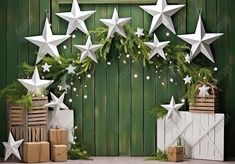 christmas decorations with white stars hanging from the ceiling and boxes on the floor next to them