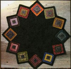 a black table top with colorful squares on it and the center is surrounded by smaller square shapes