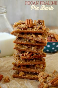 a stack of cookies sitting on top of a table next to a glass of milk