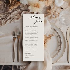 a table setting with flowers and silverware on it, including a card that reads thank you family and friends