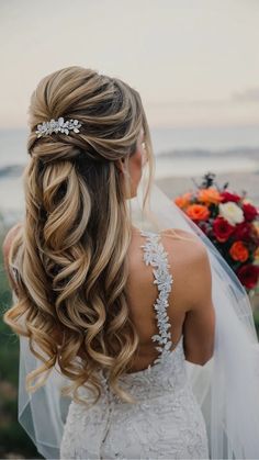 the back of a bride's head with her hair in a half - up braid