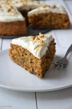 a piece of carrot cake on a plate with a fork