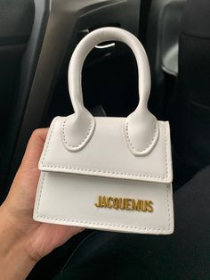 'Le chiquito' clutch dup3 Fixed rolled carry handle * Detachable and adjustable shoulder strap * Logo hardware at face * Foldover flap  * Twill lining in beige * Gold-tone hardware * H3.5 x W4.5 x D2.25 in Bags Jacquemus, Jacquemus Bags, Jacquemus Le Chiquito, Jacquemus Bag, Mini Handbag, Celine Luggage Bag, Galeries Lafayette, Mini Handbags, Givency Antigona Bag