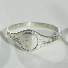 A ring many years in the making; we wondered how to say something new in the world of the signet ring, a rich and storied place. And so we say: have you met our Cygnet Ring? A reimagining of the classic signet ring it hugs you close, like a cygnet in its mother's wings.Engraving available! Rings can be left blank or engraved with the capital letter or number of your choice. All capital letters, numbers, as well an ampersand (&) are available, no other characters or punctuation. We are not able t Catbird Jewelry, How To Say, Silver Signet Ring, Capital Letters, Everyday Rings, Personalized Rings, Say Something, Punctuation, Engraved Rings