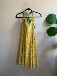 Vintage 1990s Sunflower Dress Alexandra Of California XL  🏷 XL (B: 16.5in, W: 17.6in, L: 39in)| Super kitsch 90s Alexandra Of California sunflower dress. Features adjustable tie on back and flower detailing on chest. Super fun summer dress, no flaws  🛍$78 | or get it for $17.75 with membership to bonhomievtg.com. Link in bio  *All measurements taken flat Vintage Cotton Floral Dress For Summer, Vintage Floral Dress For Spring Beach, 1970s Green Floral Print Dress, 1970s Floral Beach Dresses, Vintage Floral Print Dress For Beach, 1970s Floral Print Dress, 1970s Style Green Floral Print Dress, Vintage Floral Print Vacation Dresses, Vintage Floral Summer Dress