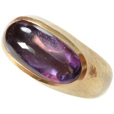 Lovely amethyst ring by London designer, Leo De Vroomen. The 18 karat gold has a lightly hand hammered finish. The amethyst measures 3/4" x 5/16". It is nicely cradled in the gold setting. Size 6 3/4 can be modified larger or smaller. The style is suitable for either a man or woman. The dark spot on the right side of the stone in the overall photos is a shadow. It is not a dent. 18k Gold Ring, London Design, Amethyst Ring, Dark Spots, Gold Ring, Fashion Rings, Gemstone Rings, 18k Gold, Jewelry Rings