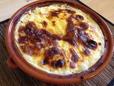 an omelet in a clay dish on a table