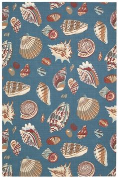 a blue background with shells and seashells printed on it, including one in the middle