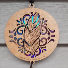 a wooden ornament hanging on the side of a door with an intricate design