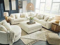 a living room filled with lots of white furniture