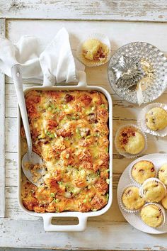 a casserole dish with meat and vegetables in it next to muffins