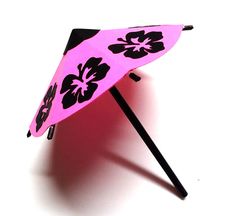 an umbrella with black and pink flowers on it is standing up against a white background