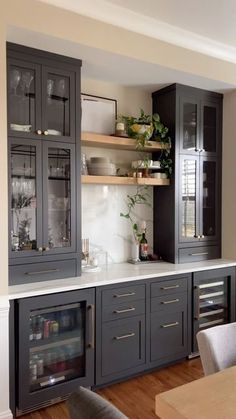 a kitchen with gray cabinets and white counter tops