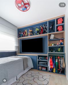 a bedroom with blue shelves and toys on the wall, along with a television set