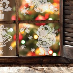 the window is decorated with christmas decorations and snowflakes, as well as santa's sleigh