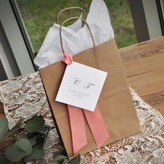 two brown paper bags sitting on top of a wooden table