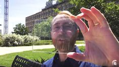 a man is holding up his face to take a selfie with the camera in front of him