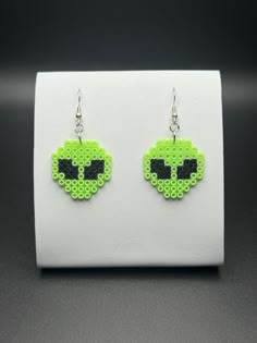 the earrings are made out of green beads