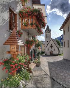 an old european village with flowers growing on the balconies