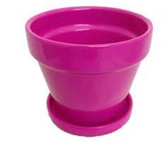 a pink plastic cup sitting on top of a white table