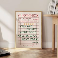 a poster with the words guest check on it in front of a desk and chair