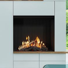 a modern fireplace with fire burning in it