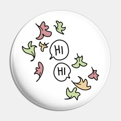 a white button with the words hh on it and leaves flying in the air