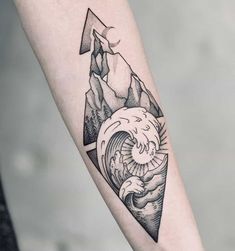 a black and white tattoo on the arm of a person with an ocean wave coming out of a mountain