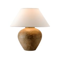 a lamp that is on top of a table with a white lampshade over it