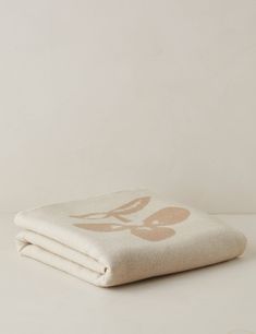 a white blanket sitting on top of a table