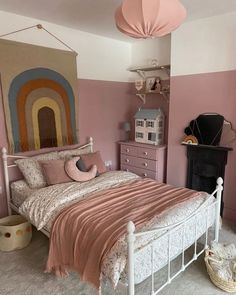 a bed room with a neatly made bed and pink walls