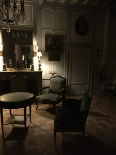 a living room filled with furniture and a chandelier