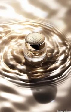 ↑↑↑ Larger size on website 🔸 A small, gold-colored jar of face cream sits in the center of a swirling, rippling pool of liquid, c 🔸 From Midjourney AI Image Gold Jars, Gold Face, The Jar, Diamond Design, Face Cream, Art Images, Jade, Lab