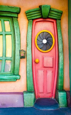 a red door with green trim and windows