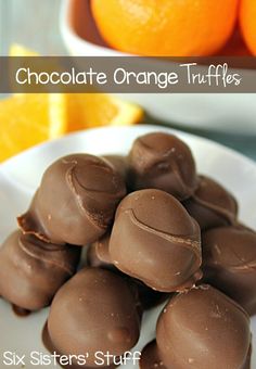 a white plate topped with chocolate covered oranges