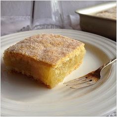 a piece of cake sitting on top of a white plate next to a silver fork