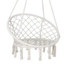 a white hanging chair with tassels