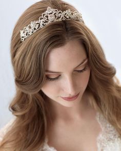 a woman wearing a tiara with pearls on it's head and long hair