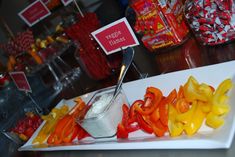 there are many different types of peppers on the plate with spoons in each one