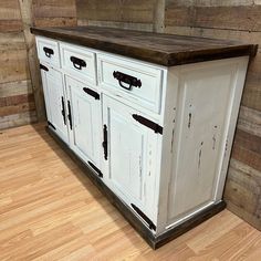 an old white cabinet with wooden top in a room