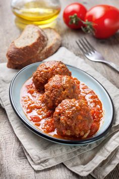 meatballs with tomato sauce and bread on a plate