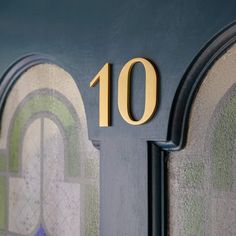 a close up of the number ten on a mailbox with an arch and arches