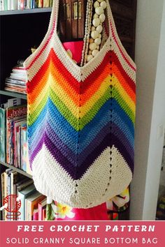 a multicolored crochet bag hanging from a book shelf with text overlay that says, free crochet pattern solid granny square bottom bag