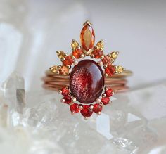 Our signature design is recreated with an oregon sunstone and red and orange sapphires making it the hottest ring set you have seen - resembles a flame and goes by the name of Marsa. Beautiful ring set which represents the beauty of flame with ombre shade colors. The set in the pictures has been sold, please contact us Flame Ring, Sunstone Ring, Sun Ring, Oregon Sunstone, Fire Ring, Gold Sapphire Ring, Sapphire Wedding Band, Engagement Sets, Sapphire Wedding