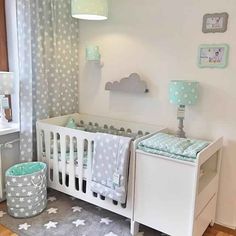 a baby's room is decorated in blue and white