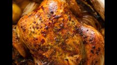 a close up of a roasted chicken with onions